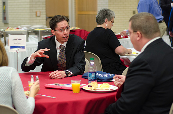 Online instructors gather for breakfast and instruction.