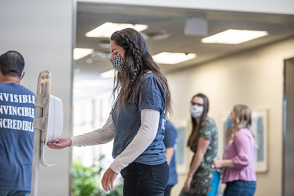 Students use hand sanitizer on campus to stay safe and healthy.
