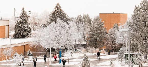 Students on campus during winter with BYUI Center in background