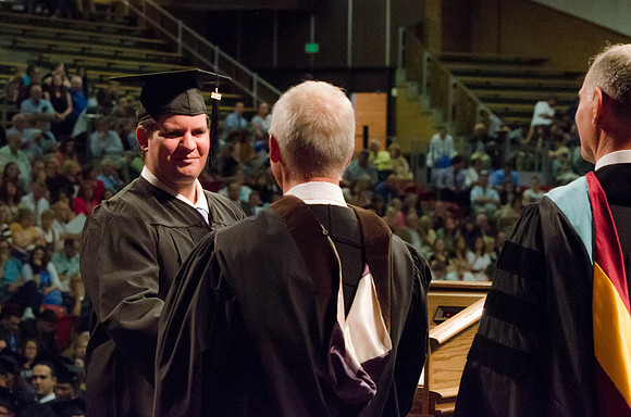 Students recieve their Diplomas during the College of Business and Communication Convocation.