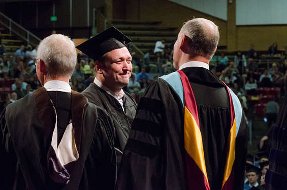 Students recieve their Diplomas during the College of Business and Communication Convocation.