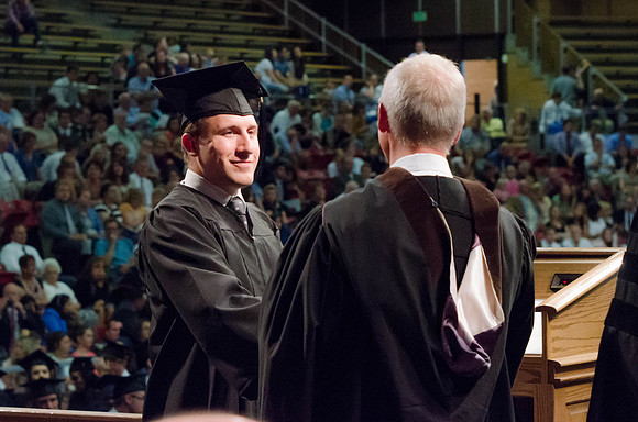 Students recieve their Diplomas during the College of Business and Communication Convocation.