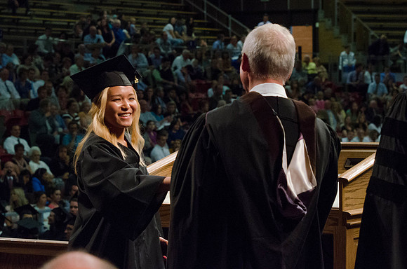 Students recieve their Diplomas during the College of Business and Communication Convocation.