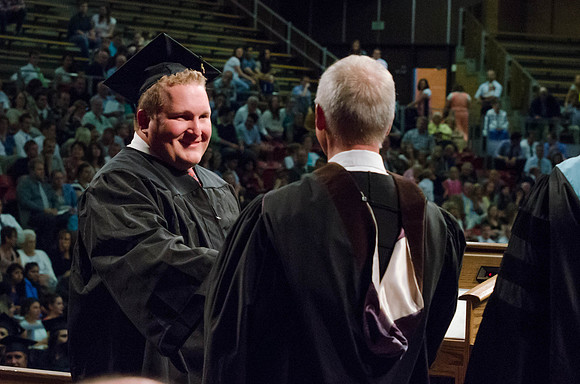 Students recieve their Diplomas during the College of Business and Communication Convocation.