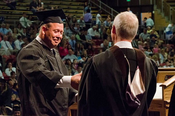 Students recieve their Diplomas during the College of Business and Communication Convocation.