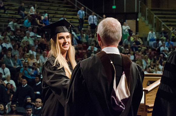 Students recieve their Diplomas during the College of Business and Communication Convocation.