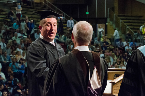Students recieve their Diplomas during the College of Business and Communication Convocation.