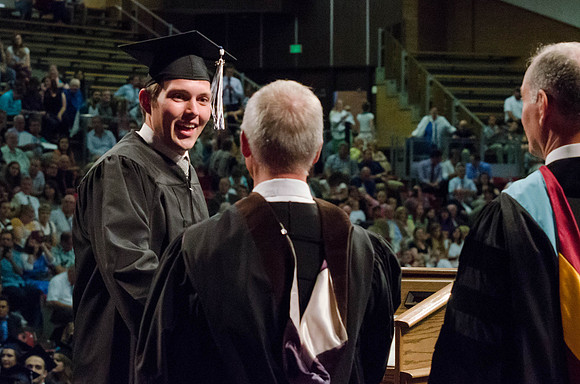 Students recieve their Diplomas during the College of Business and Communication Convocation.