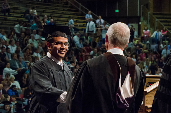 Students recieve their Diplomas during the College of Business and Communication Convocation.