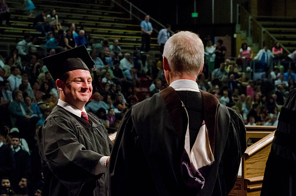 Students recieve their Diplomas during the College of Business and Communication Convocation.