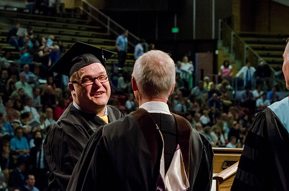 Students recieve their Diplomas during the College of Business and Communication Convocation.