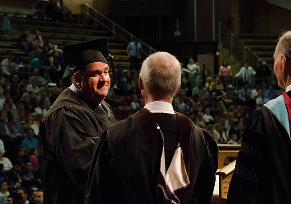 Students recieve their Diplomas during the College of Business and Communication Convocation.