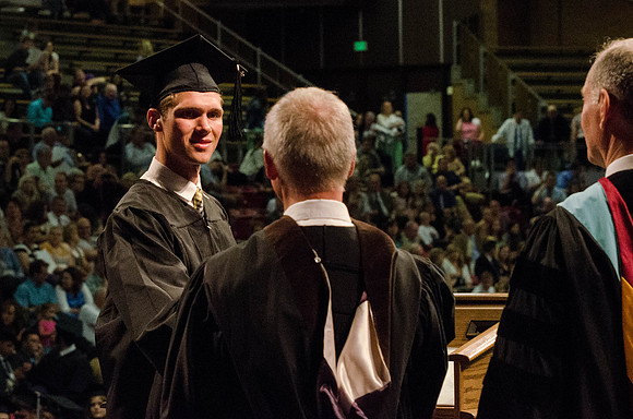 Students recieve their Diplomas during the College of Business and Communication Convocation.