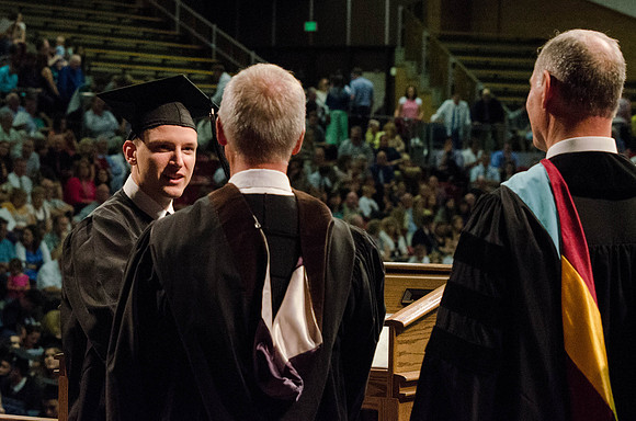 Students recieve their Diplomas during the College of Business and Communication Convocation.