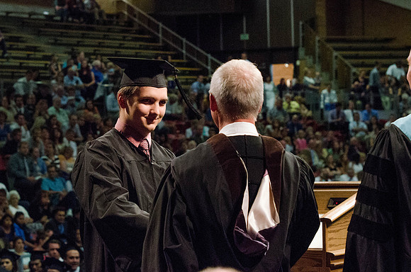 Students recieve their Diplomas during the College of Business and Communication Convocation.