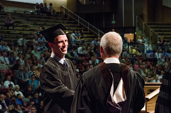Students recieve their Diplomas during the College of Business and Communication Convocation.