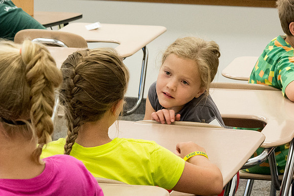 The Children discuss what their favorite part of Education Week has been so far. Photo by Erik Hill.