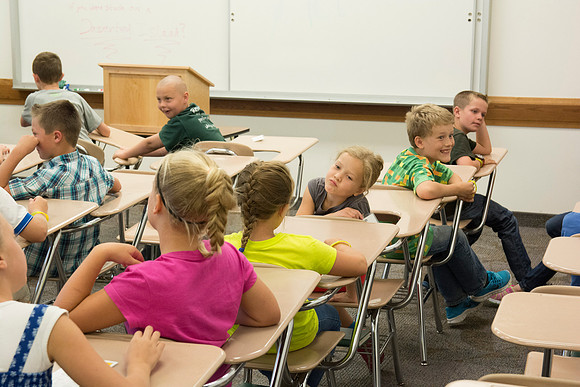 The Children discuss what their favorite part of Education Week has been so far. Photo by Erik Hill.