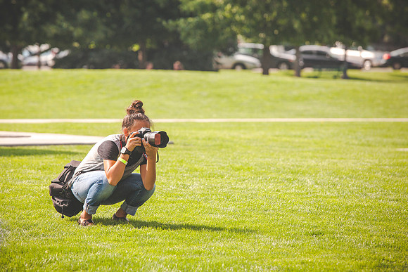 Tanya Rickenbach takes pictures during the IT Department Social at Porter Park.