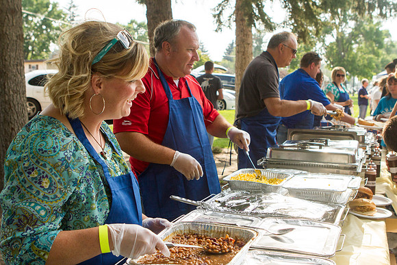 The IT Department, along with family and friends, gather at Porter Park to eat, socialize, and play games.