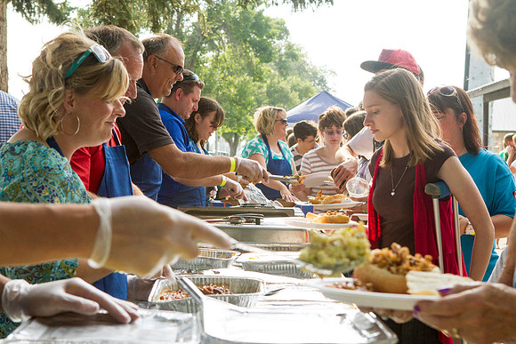 The IT Department, along with family and friends, gather at Porter Park to eat, socialize, and play games.