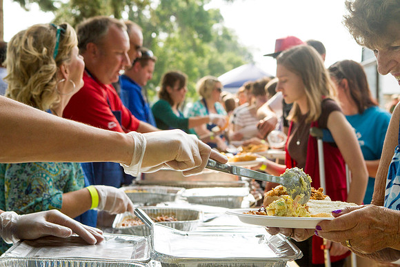 The IT Department, along with family and friends, gather at Porter Park to eat, socialize, and play games.