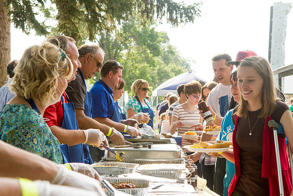 The IT Department, along with family and friends, gather at Porter Park to eat, socialize, and play games.