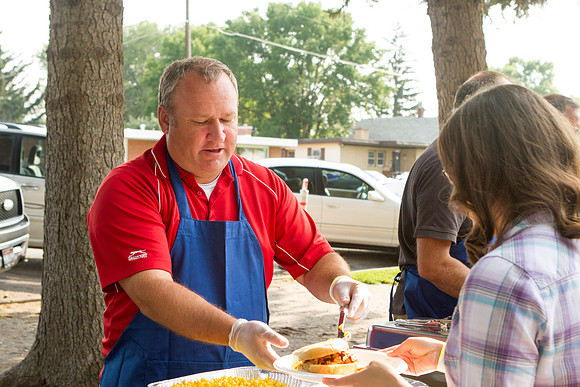 The IT Department, along with family and friends, gather at Porter Park to eat, socialize, and play games.