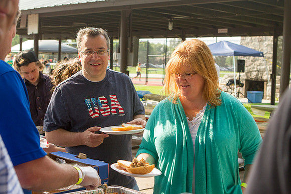 The IT Department, along with family and friends, gather at Porter Park to eat, socialize, and play games.