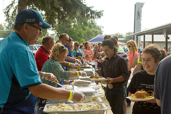 The IT Department, along with family and friends, gather at Porter Park to eat, socialize, and play games.