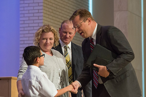 Devotional Speaker Derik Taylor with his wife Amanda and his oldest son Nathan are greeted by President Gilbert.