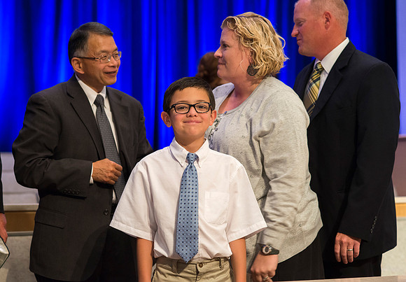 Derik Taylor with his wife Amanda visit with VP Kevin Myasaki, while Nathan gives me a big grin.