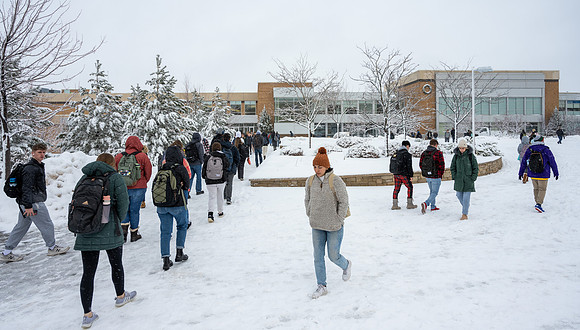 Students on campus on a snow winter day.