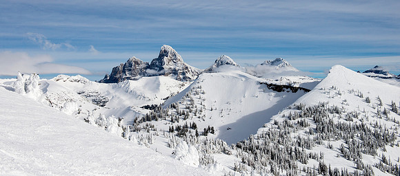 BYU-Idaho students taking a snowboarding class, snowboard with the Tetons in the background.