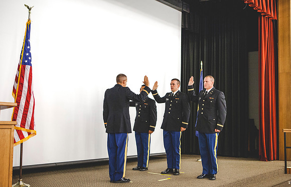 MAJ (Retired) Wilson delivers the officer's oath to 2LT Kwan-Jin Bloomfield, Joshua T. Cheesmore, and Mathew Skylar Plummer during the BYU-Idaho ROTC Commissioning Ceremony.