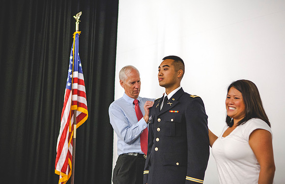 2LT Bloomfield receives gets his rank pinned on by his father Robert Bloomfield, and Tai-Lang, his sister.