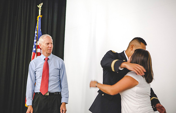 2LT Bloomfield receives gets his rank pinned on by his father Robert Bloomfield, and Tai-Lang, his sister.