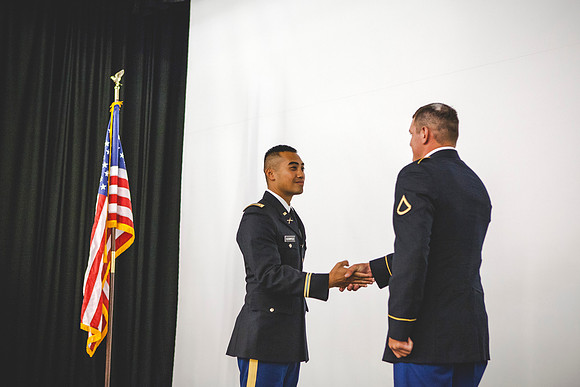 2LT Bloomfield shakes hands with PFC Jacob McKie after receiving his first salute.
