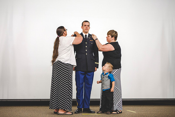2LT Joshua T. Cheesmore gets his rank pinned on by Darla Cheesmore, his wife, and Peggy Chessmore, his mother.