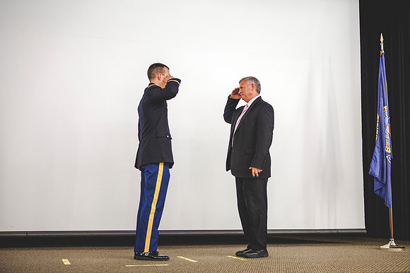2LT Joshua T. Cheesmore renders his first salute to Todd Chessmore, his father.