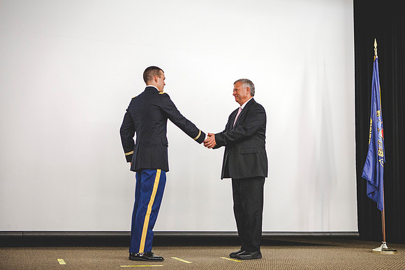 2LT Joshua T. Cheesmore renders his first salute to Todd Chessmore, his father.