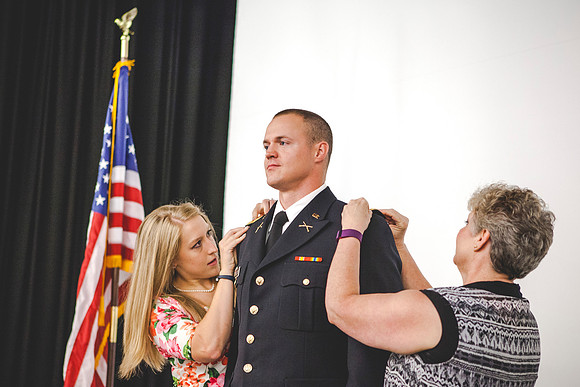 2LT Mathew Skyler Plummer gets his rank pinned on by his wife Kathryn Plummer, and his mother Brenda Plummer.