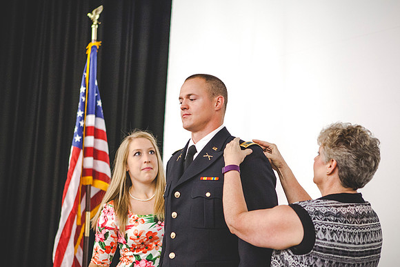 2LT Mathew Skyler Plummer gets his rank pinned on by his wife Kathryn Plummer, and his mother Brenda Plummer.