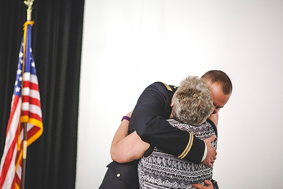 2LT Mathew Skyler Plummer hugs his mother after she pinned on her son's rank.