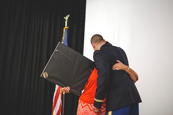 Janine Clifford gives 2LT Plummer his plaque during the Comissioning Ceremony.