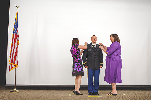 2LT Geiger gets his rank pinned on by wife and mother during the Commissioning Ceremony.