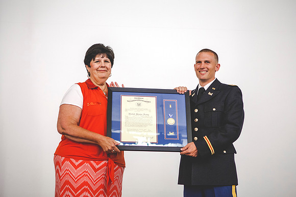 2LT Geiger and Sister Clifford from ROTC Department smile for the camera during the Comissionging Ceremony.
