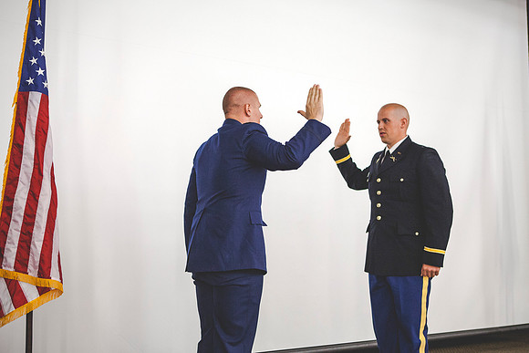 2LT John R. Flanigan, is sworn in my 1LT Mark Flanigan (Air Force) during the BYU-Idaho ROTC Commissioning Ceremony.