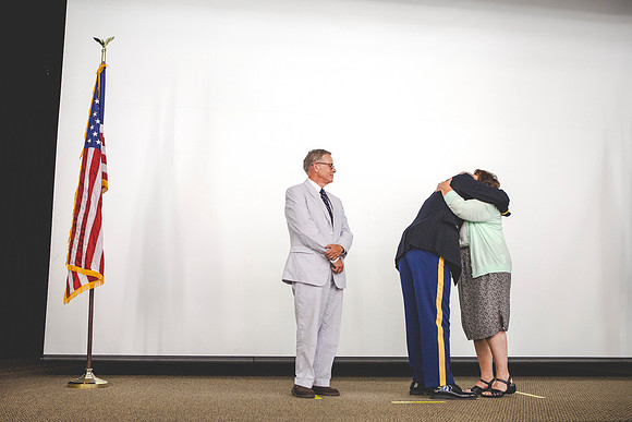 2LT John R. Flanigan get his rank pinned onto his uniform from Tim and Katie Flanigan during the BYU-Idaho ROTC Comissioning Ceremony.