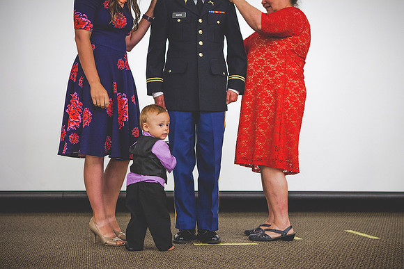 2LT Benjamin Mars gets his rank pinned on by his wife Hannah Mars and his mother during the Commissioning Ceremony.